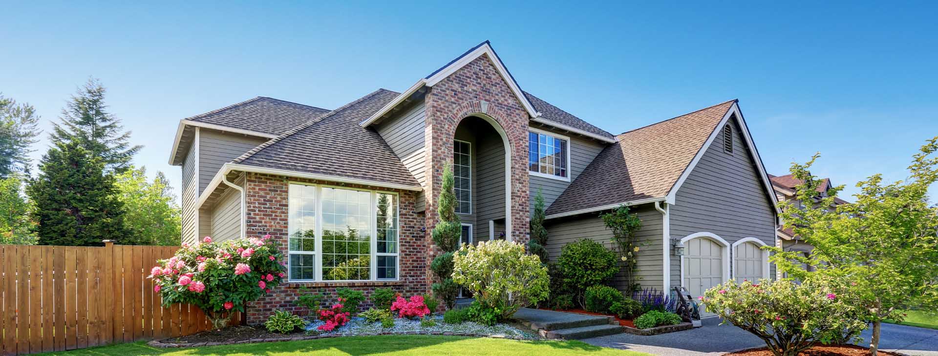 Charming suburban home with brick and wood exterior - https://pintlerinsurance.com/